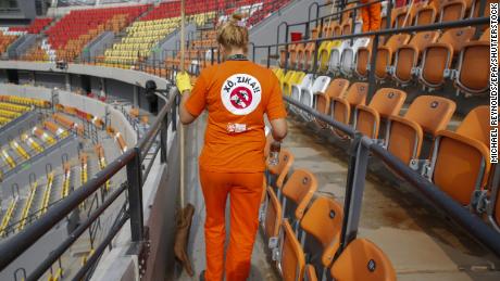 A cleaner at Rio&#39;s Olympic Tennis Center wears a shirt with an anti-Zika slogan, August 2016.